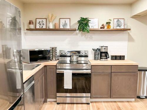 a kitchen with a stainless steel stove top oven at Cozy Mountainside Den in Steamboat Springs