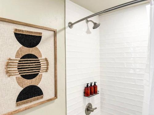 a bathroom with a shower with a picture on the wall at Cozy Mountainside Den in Steamboat Springs