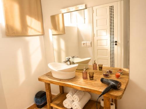 a bathroom with a sink and a mirror at Riad Chama in Essaouira