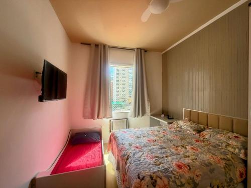 a small bedroom with a bed and a window at Dream Home Icaraí Niterói in Niterói