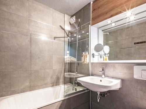 a bathroom with a sink and a mirror at greet Hotel Massieux Lyon Nord by All Accor in Massieux