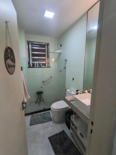 a bathroom with a sink and a toilet and a mirror at Dream Home Icaraí Niterói in Niterói