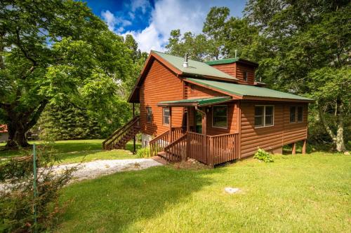 a small wooden house with a porch on a yard at Serenity Summit in Banner Elk