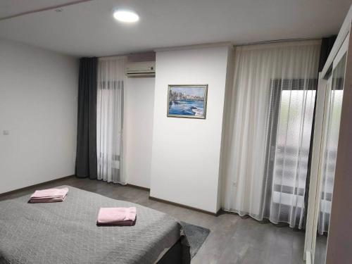 a bedroom with a bed with pink towels on it at Markaz Apartman Bihac in Bihać
