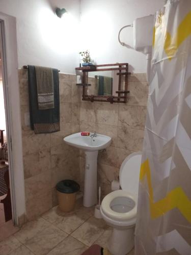 a bathroom with a toilet and a sink at Hospedaje Nely in San Vicente