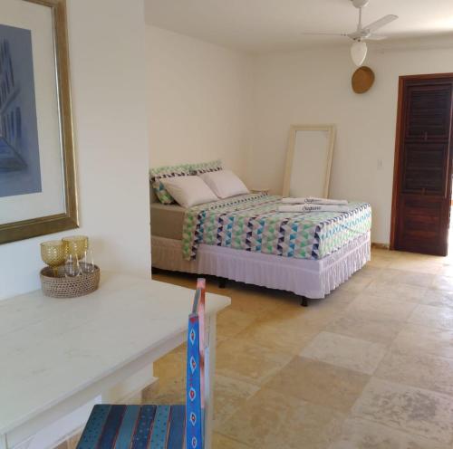 a bedroom with a bed in the corner of a room at Vila Saguaro in Flecheiras