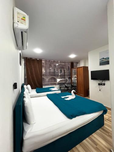 a room with three beds with swans on them at The Rivénto Boutique with Breakfast - Downtown,Cairo in Cairo