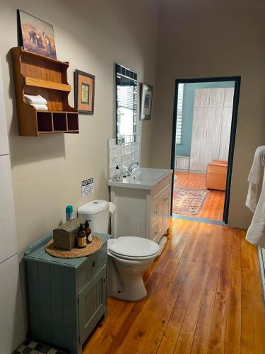 a bathroom with a toilet and a sink at RHOOM in Burgersdorp