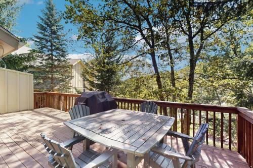 a wooden table and chairs on a deck at Vista at Camelback Mountain in Tannersville