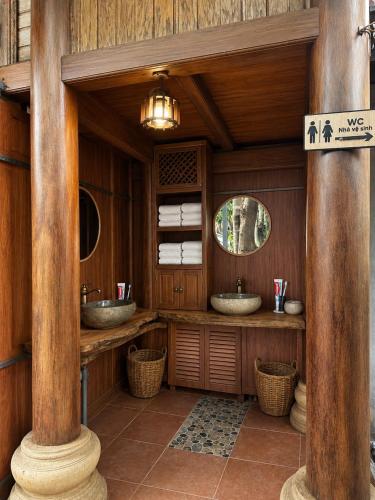 a bathroom with two sinks and two mirrors at OH Pu Luong Homestay in Làng Bang