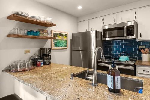 a kitchen with a stainless steel refrigerator and a sink at Restful Rockies Overlook in Steamboat Springs