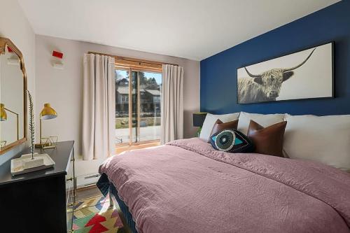 a bedroom with a bed with a bull on the wall at Restful Rockies Overlook in Steamboat Springs
