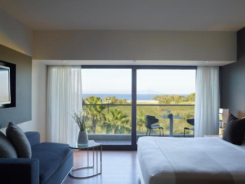 a bedroom with a bed and a view of the ocean at Aqua Blu Boutique Hotel & Spa, Adults Only in Kos