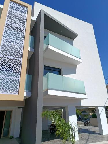 a facade of a house with blue balconies at Olympus Hospitality Rhodes in Rhodes Town
