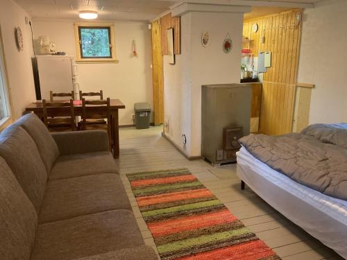 a living room with a couch and a table at Kalliotupa in Haapakylä
