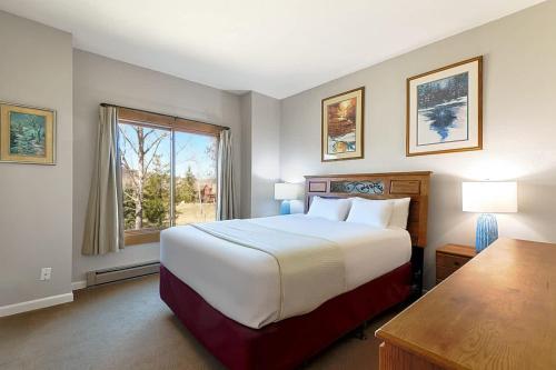 a bedroom with a large bed and a window at Rockies Alpine Haven in Steamboat Springs