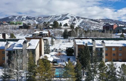 a city covered in snow with mountains in the background at Rockies Alpine Haven in Steamboat Springs