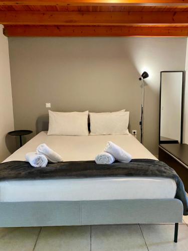 a bedroom with a bed with two pillows on it at A&D Houses No3 in Patra