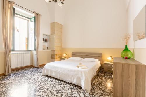 a bedroom with a white bed and a window at Rifugio del Sole in Cutrofiano