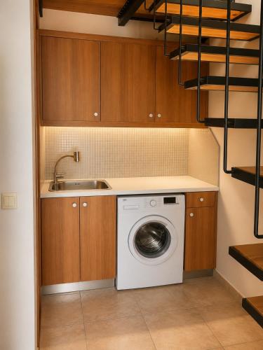 a kitchen with a washing machine and a sink at Margarita's Villas in Chania