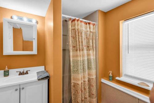 a bathroom with a shower curtain and a sink at 4BR Bungalow Steps to the Beach in Seaside Heights