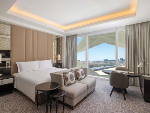 a hotel room with a bed and a couch at Sofitel Riyadh Hotel & Convention Centre in Riyadh