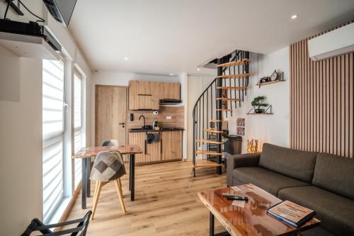 a living room with a couch and a table at EnergyZen - Spa Alsace - le Refuge des Anges in Bischoffsheim
