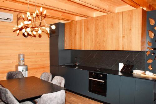 a kitchen with a table and a black counter top at Batllava Premium Resort Villa's in Orllan
