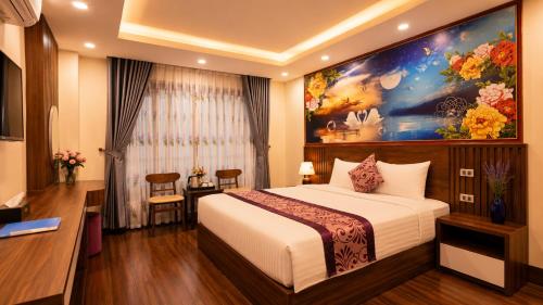 a hotel room with a bed and a painting on the wall at Lavender SaPa Hotel & Spa Right in the center of Sa Pa - Free foot soak service in Lao Cai