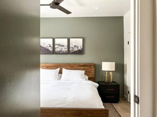 a bedroom with a bed and a ceiling fan at Alpenglow Bungalow in Steamboat Springs