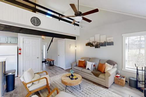 a living room with a couch and a ceiling fan at The Pocono Loft in Lake Harmony