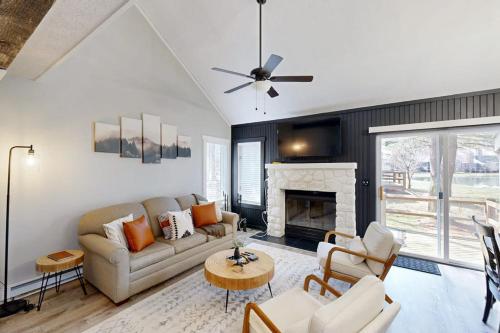 a living room with a couch and a fireplace at The Pocono Loft in Lake Harmony