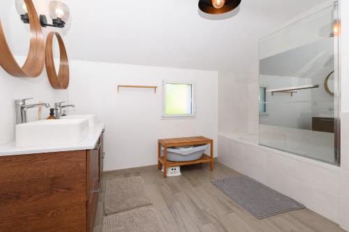 a bathroom with a sink and a tub and a shower at Maison de vacances Plouharnel 3star in Plouharnel