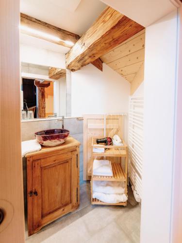 a bathroom with a sink and a wooden cabinet at Landlust Ischl in Bad Ischl