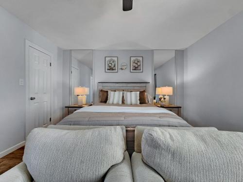 a bedroom with a large bed and a couch at Silk Oak Tempe in Tempe
