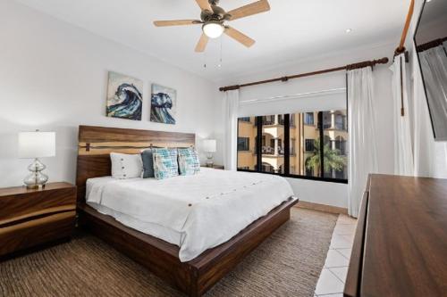 a bedroom with a bed and a ceiling fan at Oceanview Condo Across From Beach with Resort Pool in Tamarindo
