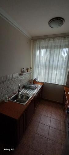 a kitchen with a sink and a window at Favorite apartment in Hévíz
