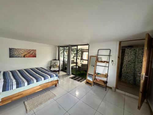 a bedroom with a bed and a glass door at Seaside View Terrace Apartment in Mauritius