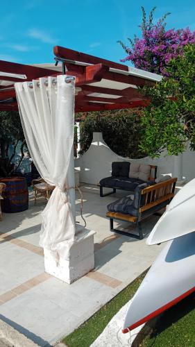a patio with a canopy and a couch and a table at Apartments Bulovic Bozo Ap1 in Podglavica