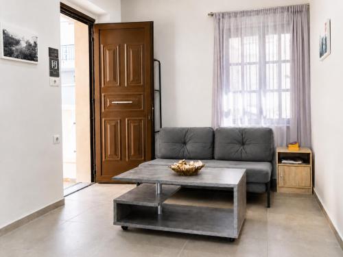 a living room with a couch and a coffee table at 9-4 Private Houses in Kos