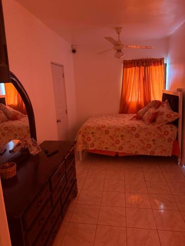 a bedroom with two beds and a dresser in it at Mary Vilaseca in SJM