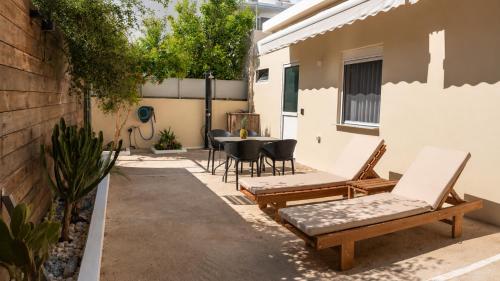 a patio with chairs and a table in a backyard at 9-4 Private Houses in Kos