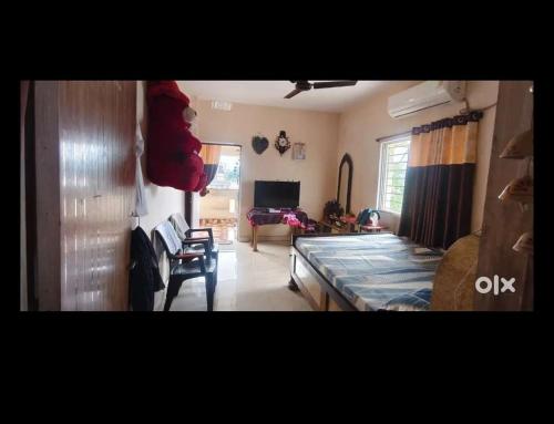 a living room with a bed and a couch at OM Tower in Jamshedpur