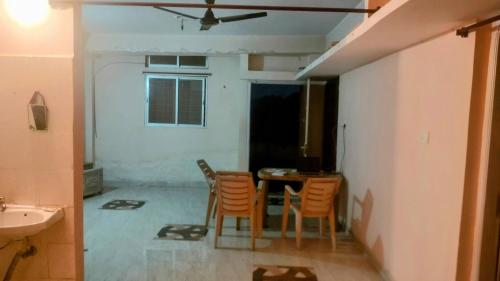 a kitchen with a table and chairs in a room at OM Tower in Jamshedpur