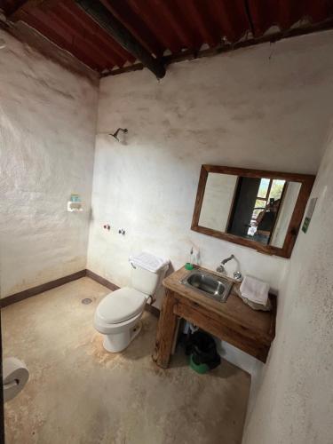 a bathroom with a toilet and a sink at La Misión Hotel Chignahuapan in Chignahuapan