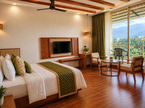 a hotel room with a bed and a television at The Signature Munnar in Munnar