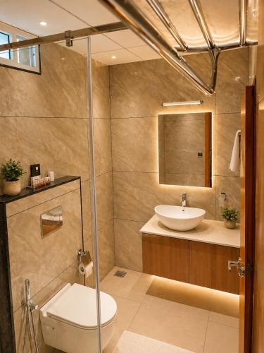 a bathroom with a toilet and a sink at The Signature Munnar in Munnar