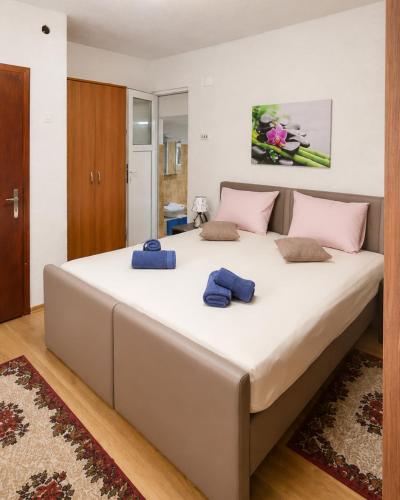 a large bed in a bedroom with two blue towels on it at Villa Indigo in Berovo