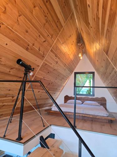 a camera on a tripod in a room with a bed at The Quiet Wild in Briska Gora