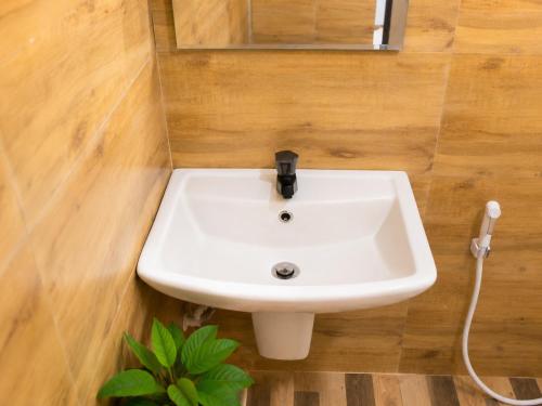 a white sink in a bathroom with a mirror at Haputala Blossom guest in Haputale